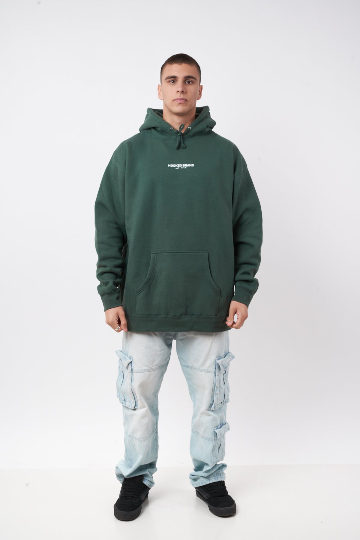 Man wearing a green hoodie with text on a white background