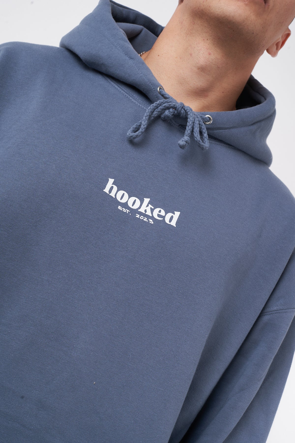 Blue hoodie with 'hooked' logo on a white background