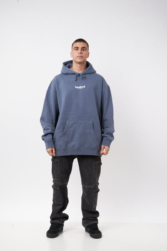 Person wearing a blue hoodie with a brand logo on a white background